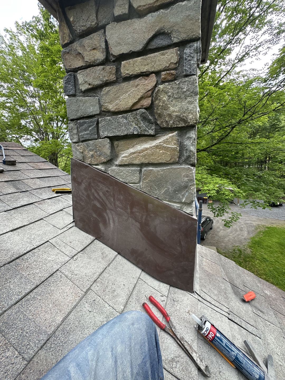 Close-up of the roof flashing detail on the finished stone chimney