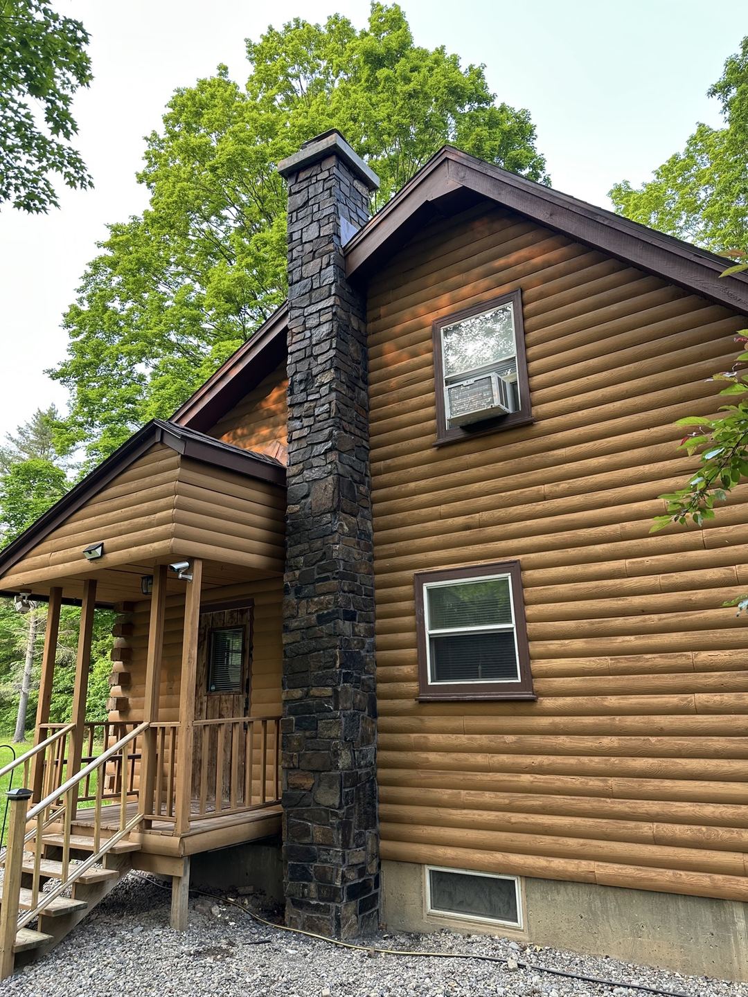 Wide view of the finished stone chimney on the cabin
