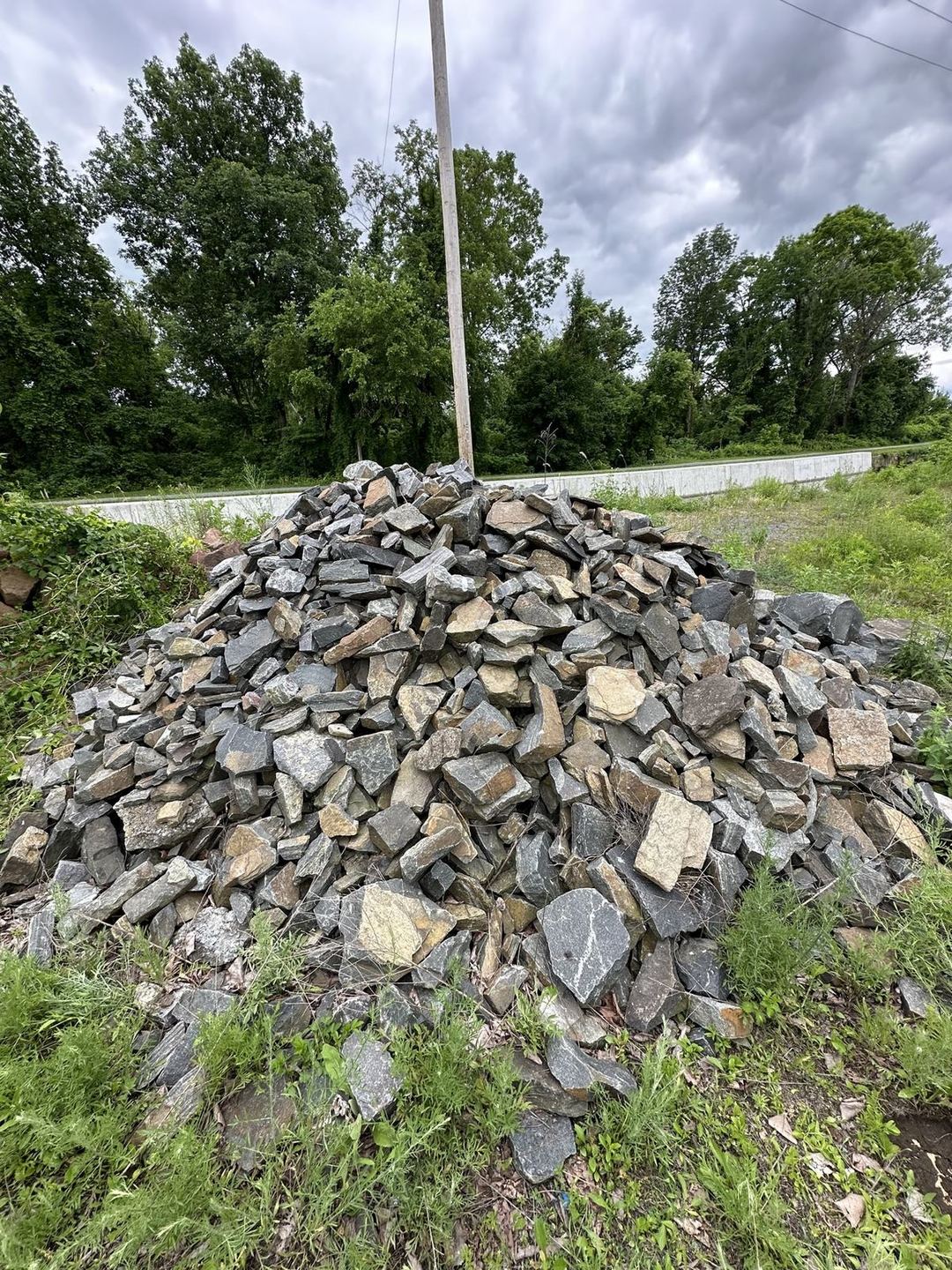 Pile of stone veneer material staged on site next to the cabin