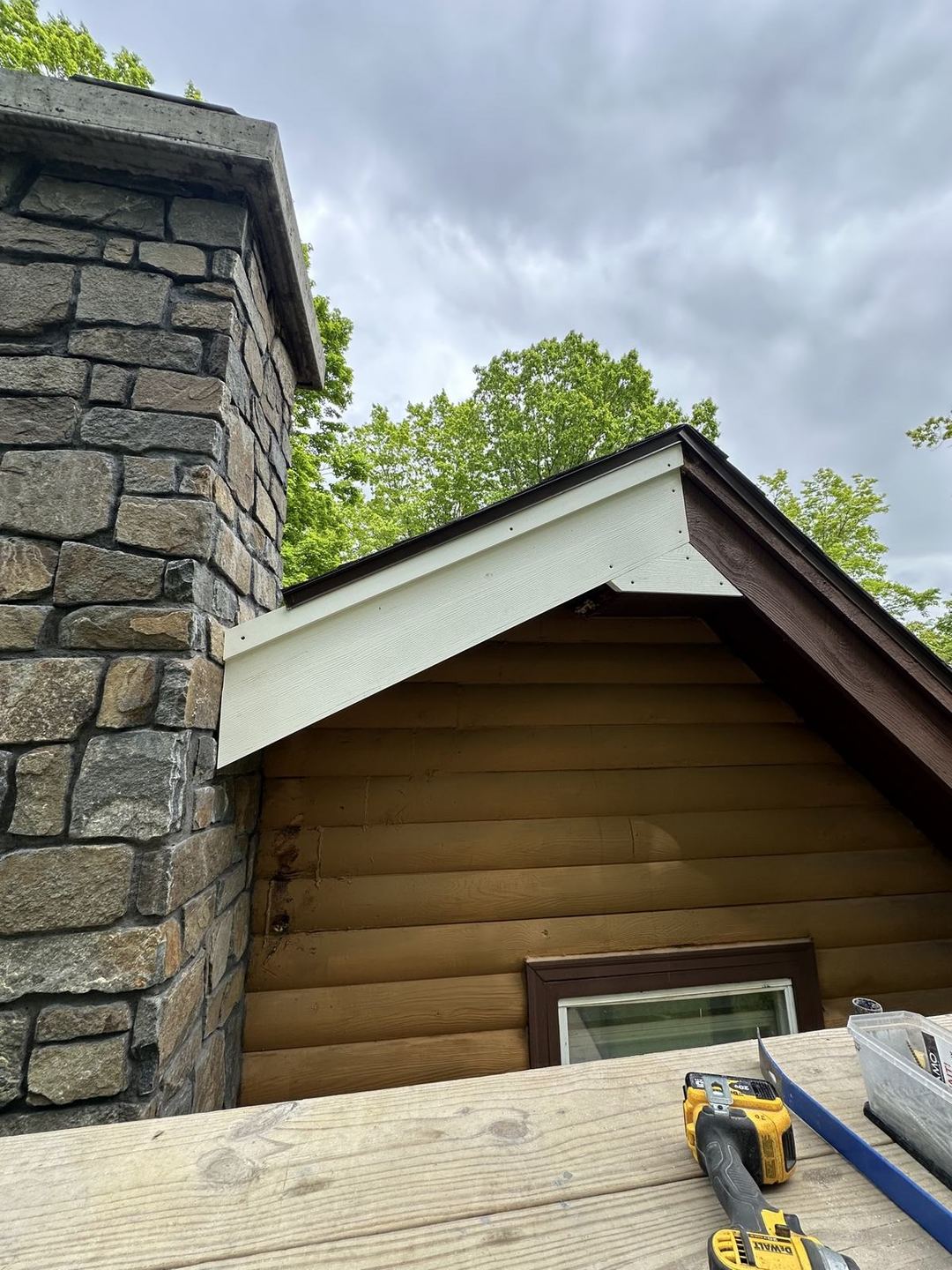 Finished stone chimney close-up showing gable flashing detail